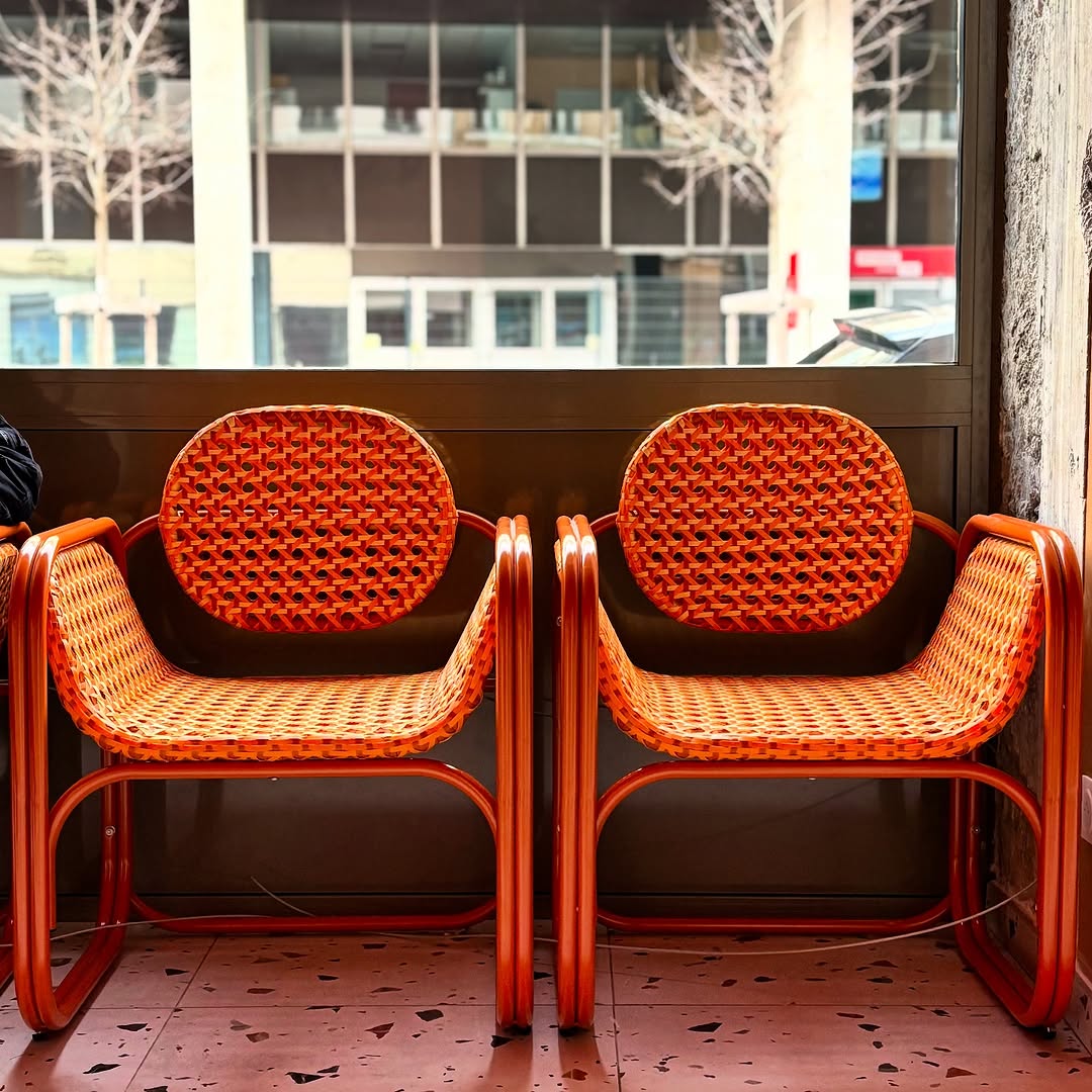 Comfortable retro orange wicker chairs in the waiting area of Relax a Wash laundrette